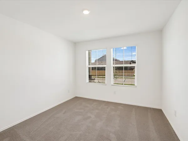 an empty room with a empty space and windows
