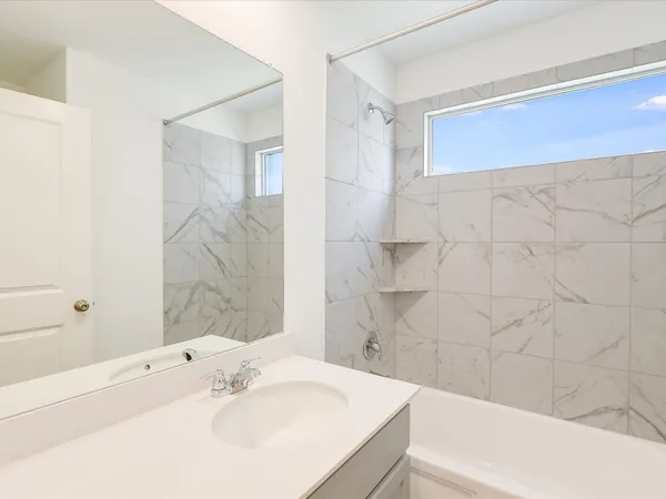 a bathroom with a sink a mirror and a bathtub