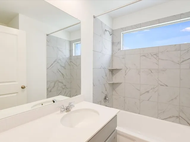 a bathroom with a sink a mirror and a bathtub