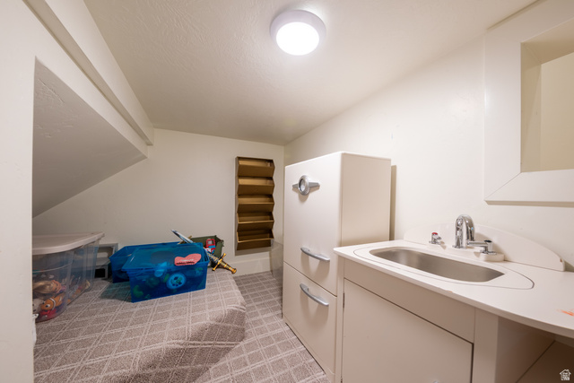 630 East Center Street Alpine, UT 84004 - Photo 70 of 115 Compact utility space featuring a built-in sink with a chrome faucet, overhead flush-mount lighting, and patterned floor tile