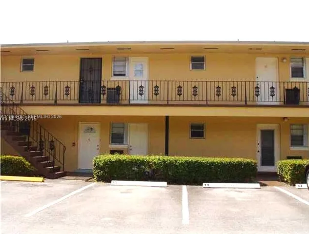 a front view of residential houses with yard