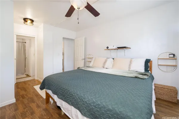 a bedroom with a bed and a chandelier