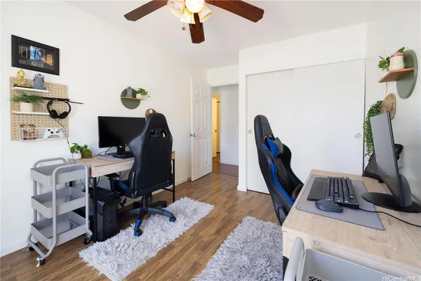 a view of a workspace with furniture and gym equipment