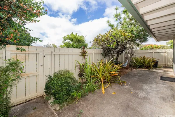 a view of a backyard with plants and a lake view