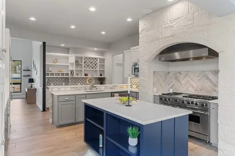 a kitchen that has a stove and a table in it