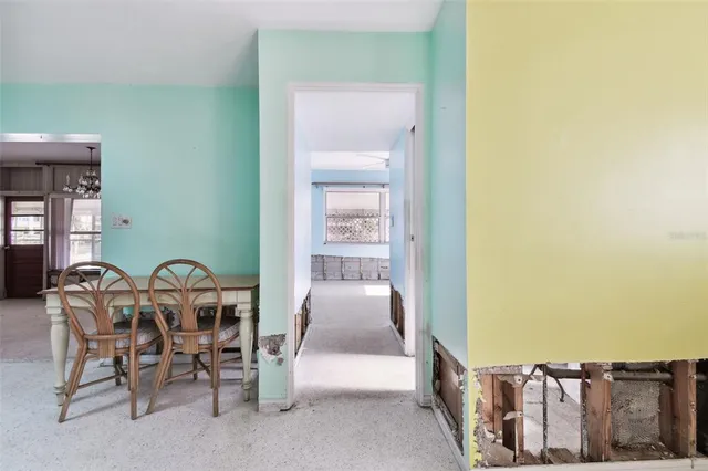 a large bed sitting in a room next to a window