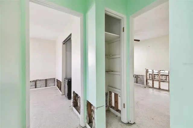 a view of a ocean with boats and trees in the background