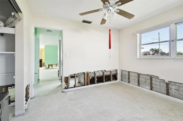 a view of a ocean with boats and trees in the background