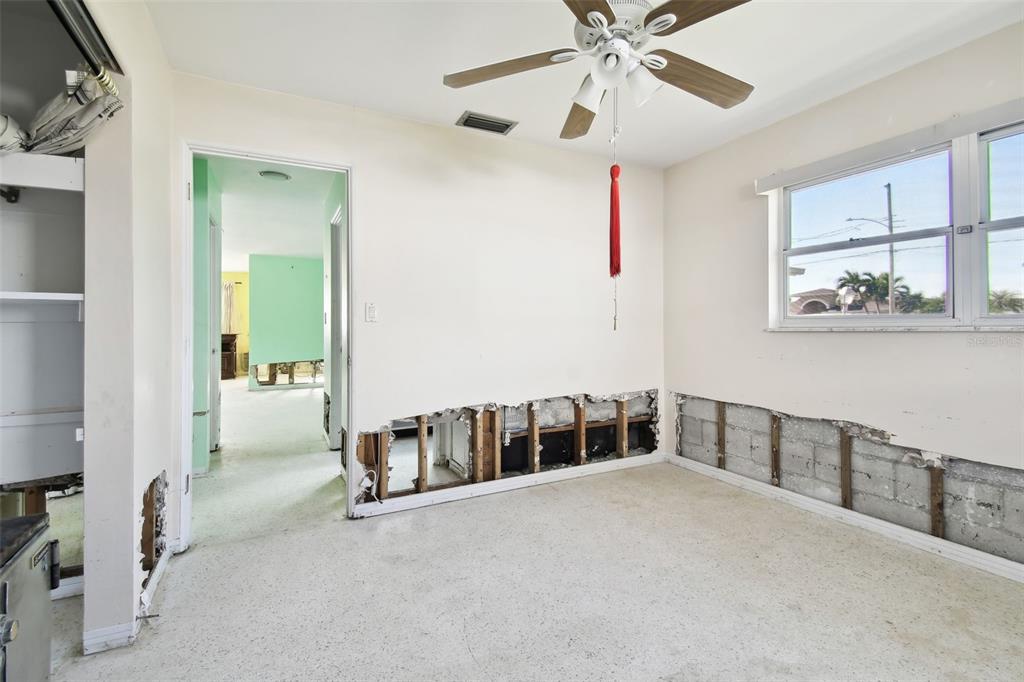 545 Lillian Drive Madeira Beach, FL 33708 - Photo 44 of 100 a view of an empty room with window and a ceiling fan