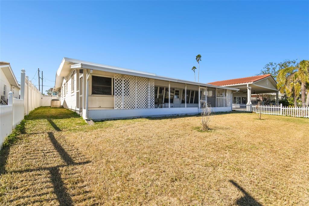 545 Lillian Drive Madeira Beach, FL 33708 - Photo 57 of 100 a swimming pool with outdoor seating
