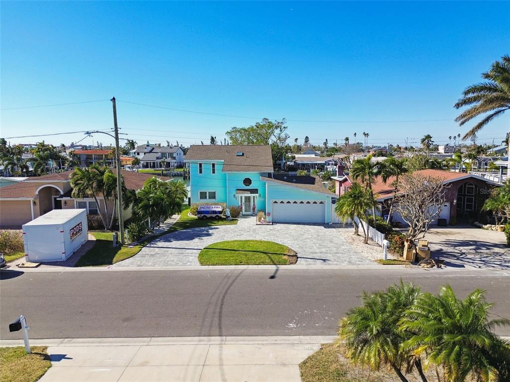 545 Lillian Drive Madeira Beach, FL 33708 - Photo 74 of 100 a view of a swimming pool and a lounge chair