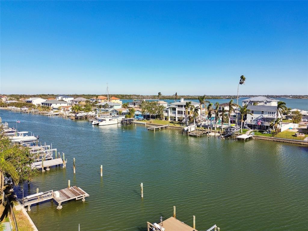 545 Lillian Drive Madeira Beach, FL 33708 - Photo 85 of 100 a view of a ocean with boats and trees in the background