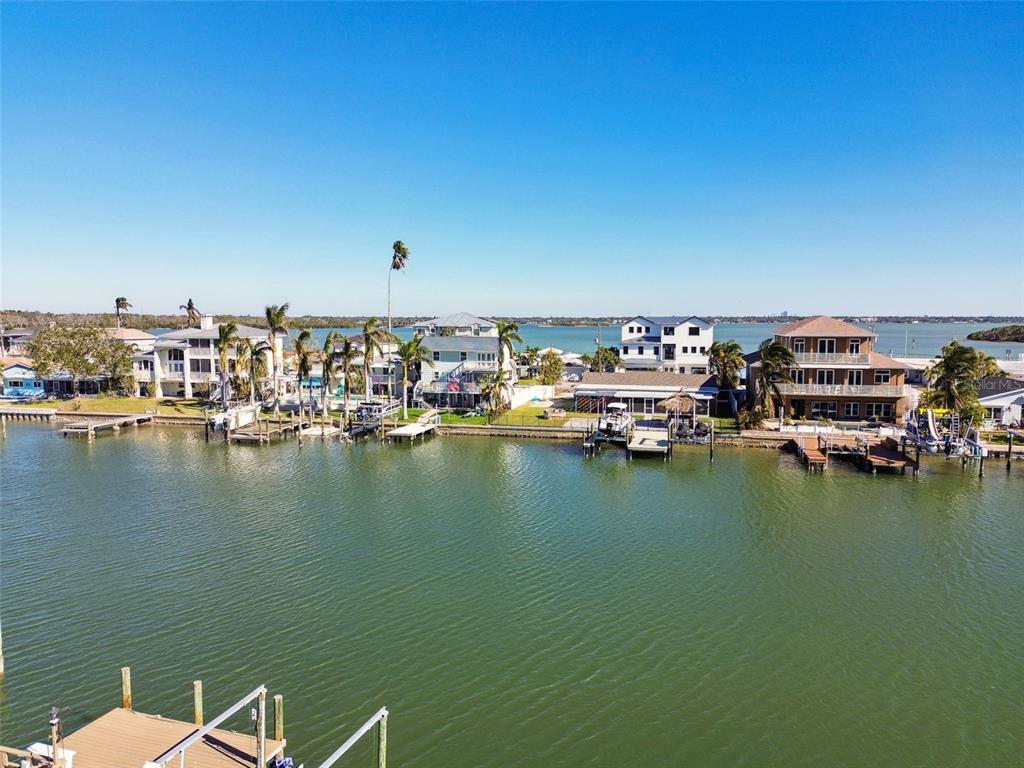 545 Lillian Drive Madeira Beach, FL 33708 - Photo 88 of 100 a view of a ocean with boats and trees in the background