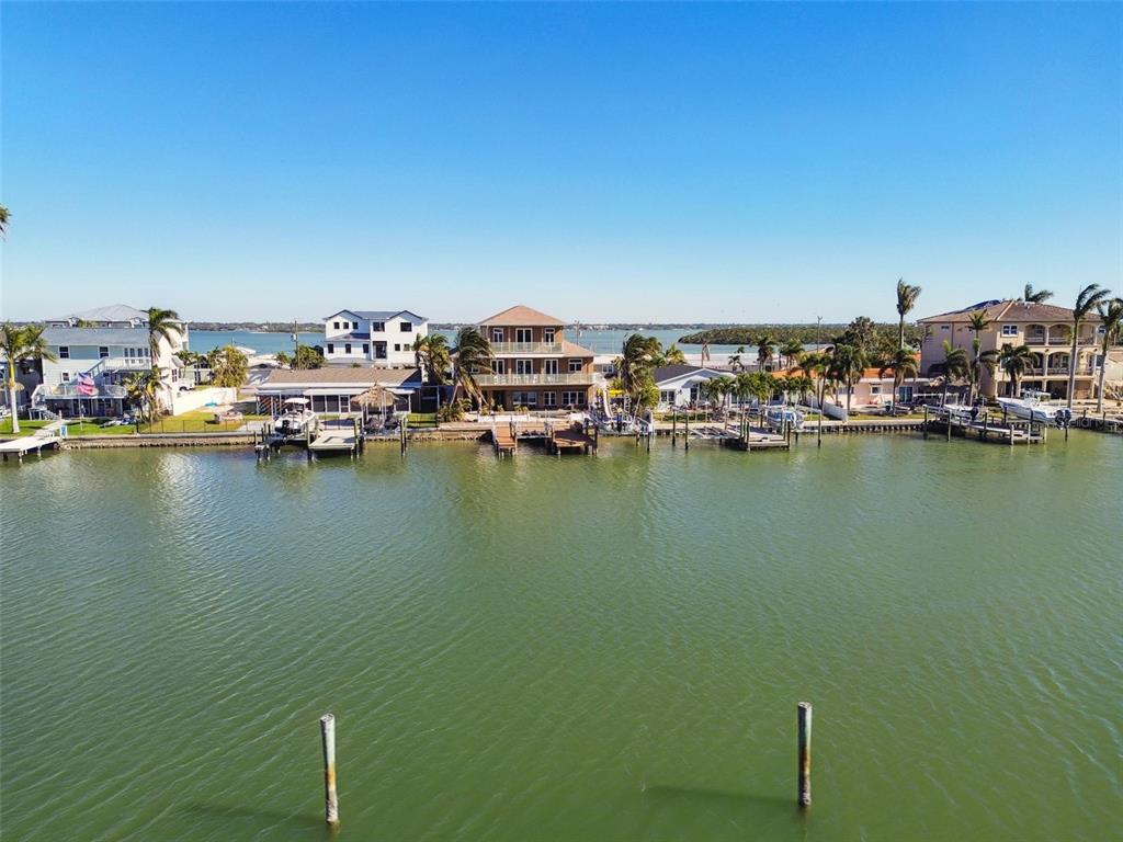 545 Lillian Drive Madeira Beach, FL 33708 - Photo 90 of 100 a view of a ocean with boats and trees in the background