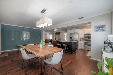 a view of a dining room with furniture and wooden floor