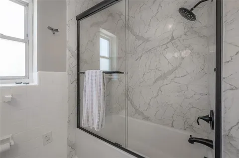 a bathroom with a bathtub and a shower