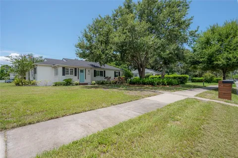 a house view with swimming pool and garden space