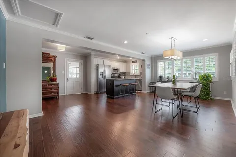a view of a dining room with furniture and wooden floor