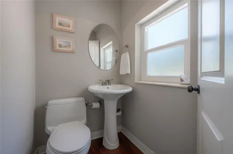 a bathroom with a toilet sink and mirror