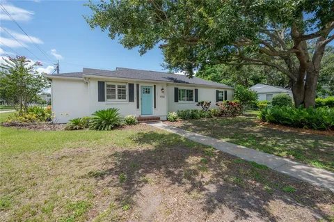 a front view of house with yard and trees