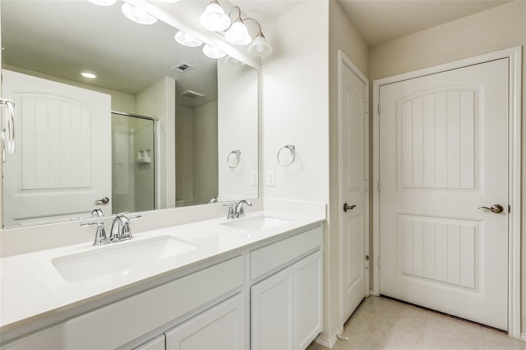 7793 Gulf Walk Road Frisco, TX 75036 - Photo 17 of 28 a bathroom with a sink a vanity and a mirror