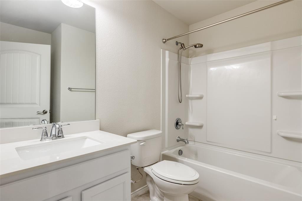 7793 Gulf Walk Road Frisco, TX 75036 - Photo 20 of 28 a bathroom with a sink toilet vanity and shower