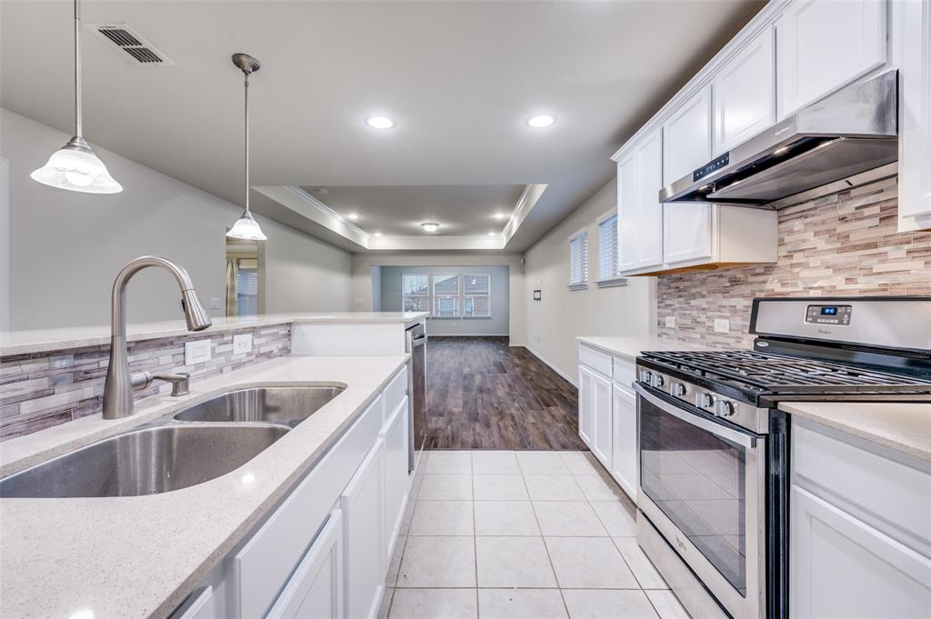 7793 Gulf Walk Road Frisco, TX 75036 - Photo 4 of 28 a kitchen with sink cabinets and window
