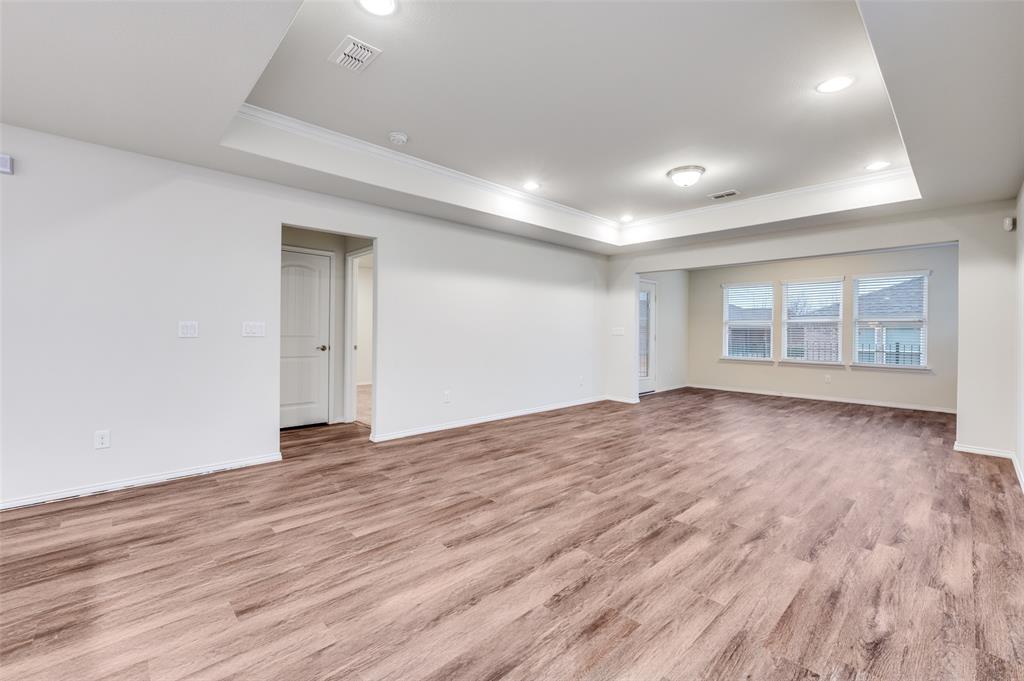 7793 Gulf Walk Road Frisco, TX 75036 - Photo 8 of 28 an empty room with wooden floor and windows