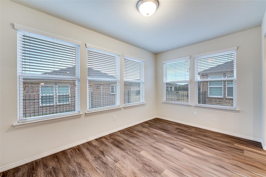 7793 Gulf Walk Road Frisco, TX 75036 - Photo 9 of 28 a view of an empty room with wooden floor and a window