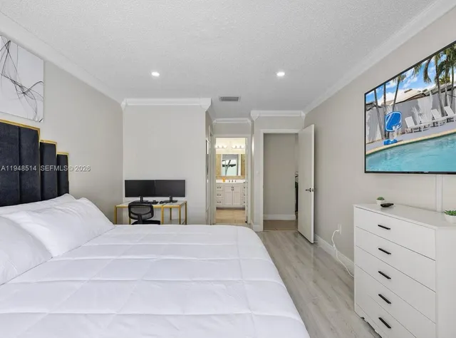 a bedroom with a large bed and a dresser