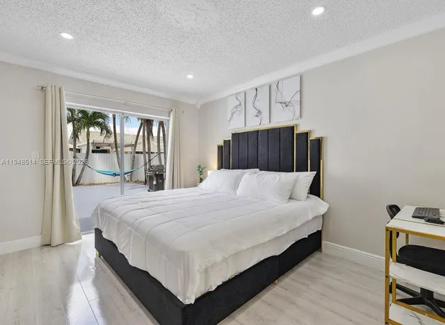 a large white bed in a white room