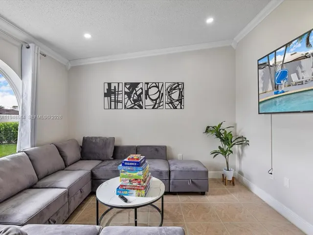 a living room with furniture and a potted plant