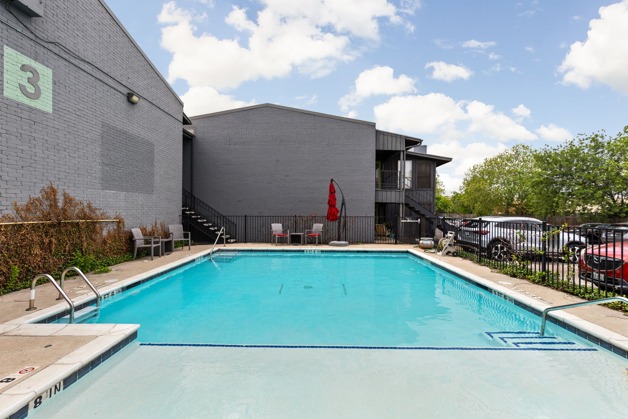 909 Reinli Street, Unit 232 Austin, TX 78751 - Photo 12 of 13 a view of a swimming pool with a lounge chairs