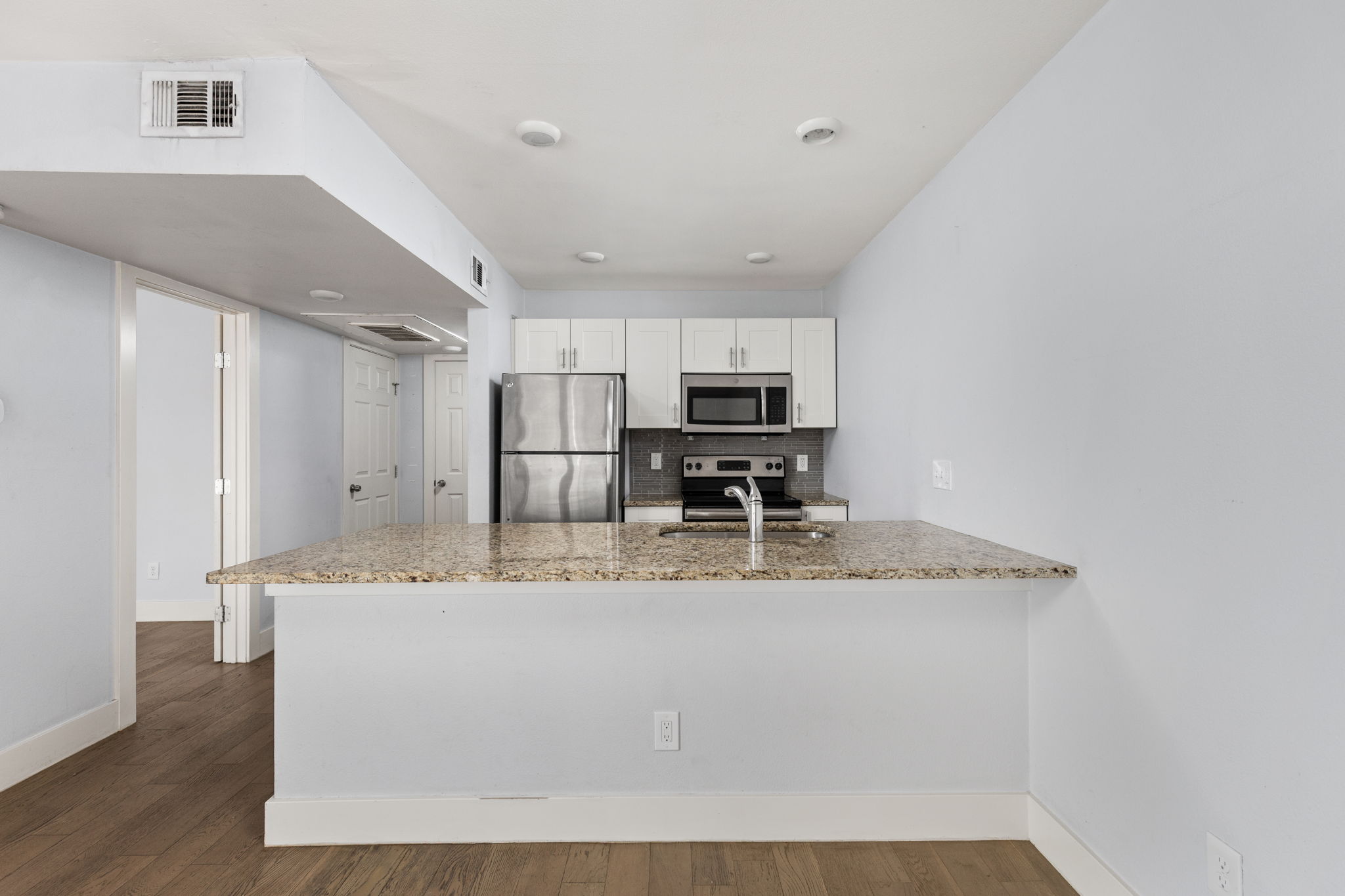 909 Reinli Street, Unit 232 Austin, TX 78751 - Photo 7 of 13 a kitchen with stainless steel appliances granite countertop a sink a refrigerator and a granite counter tops