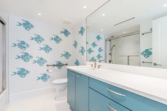 a bathroom with a sink a toilet and shower curtain