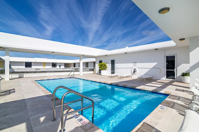 a view of a kitchen with a dining table and chairs