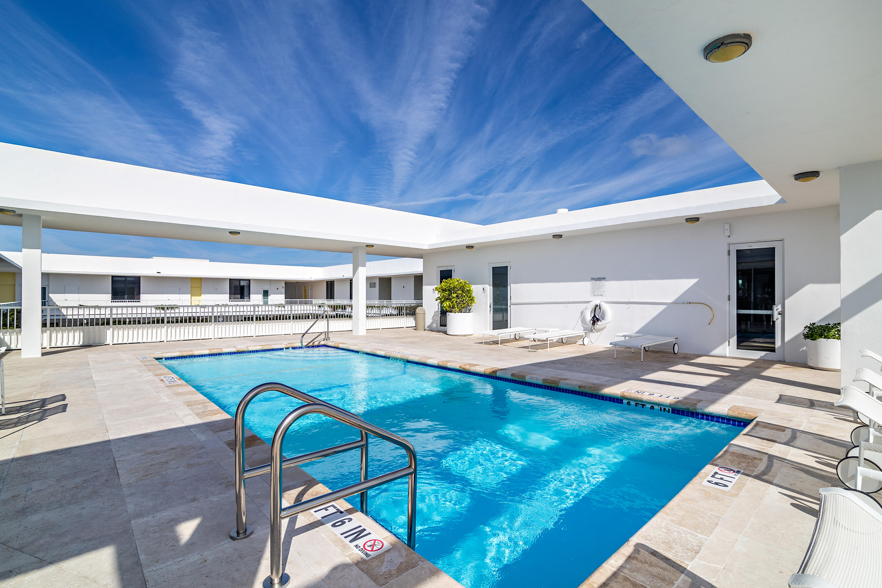 400 South Ocean Boulevard, Unit 419 Palm Beach, FL 33480 - Photo 15 of 24 a view of a kitchen with a dining table and chairs