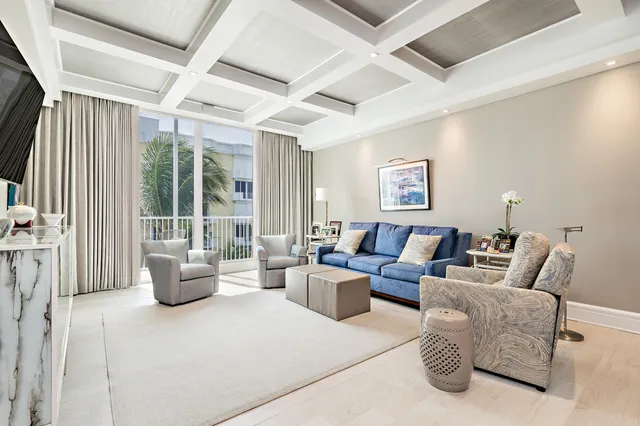a living room with furniture and large windows