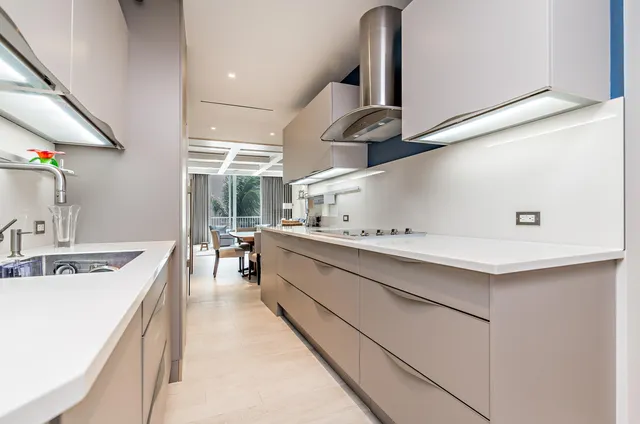 a kitchen with stainless steel appliances a sink a stove and cabinets