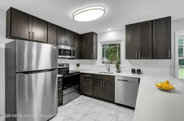 a kitchen with stainless steel appliances a refrigerator and a sink