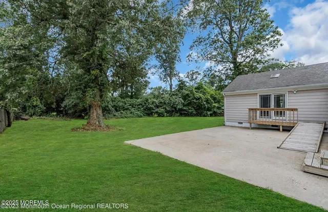 a view of a house with a backyard