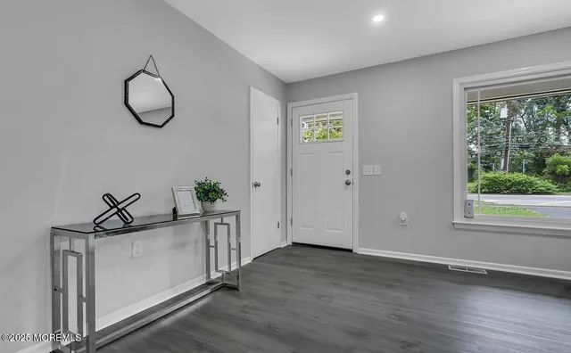 a view of a room with wooden floor and window