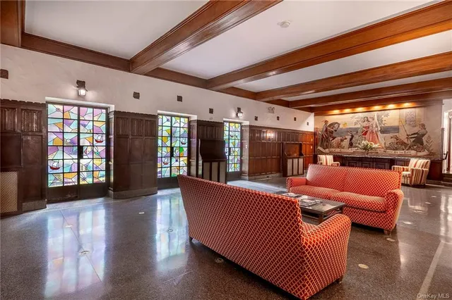a living room with furniture and large windows