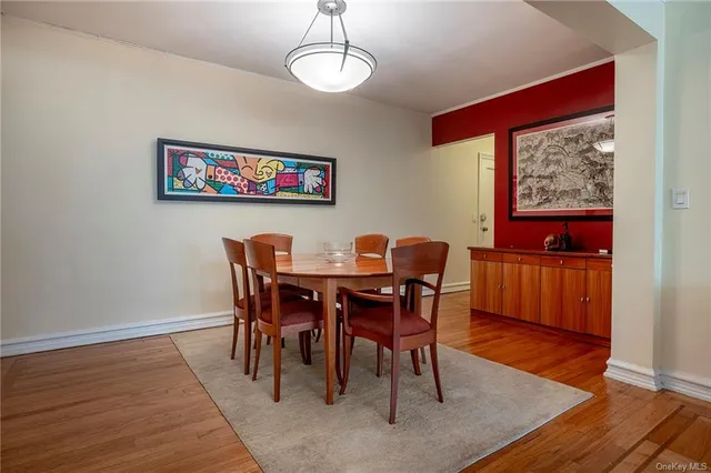 a view of a dining room with furniture wooden floor and a chandelier
