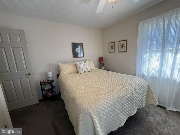 a spacious bedroom with a bed and a chandelier