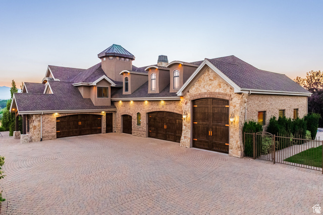 694 West Cephus Road Draper, UT 84020 - Photo 130 of 148 Stone and stucco exterior featuring multiple garage bays with wood-finish doors