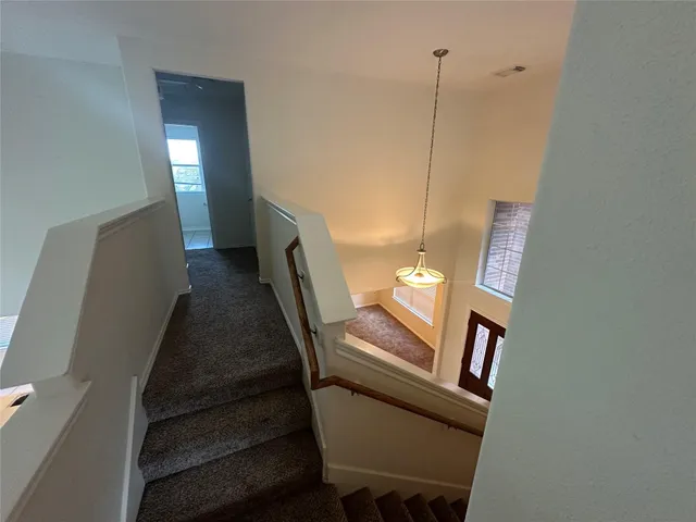 a view of a hallway with stairs