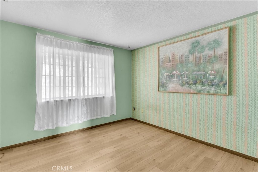 7633 I Avenue Hesperia, CA 92345 - Photo 11 of 22 an empty room with wooden floor and windows