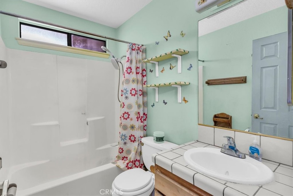 7633 I Avenue Hesperia, CA 92345 - Photo 13 of 22 a bathroom with a sink toilet and shower