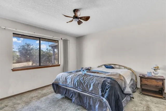 a bedroom with a bed and a painting on the wall